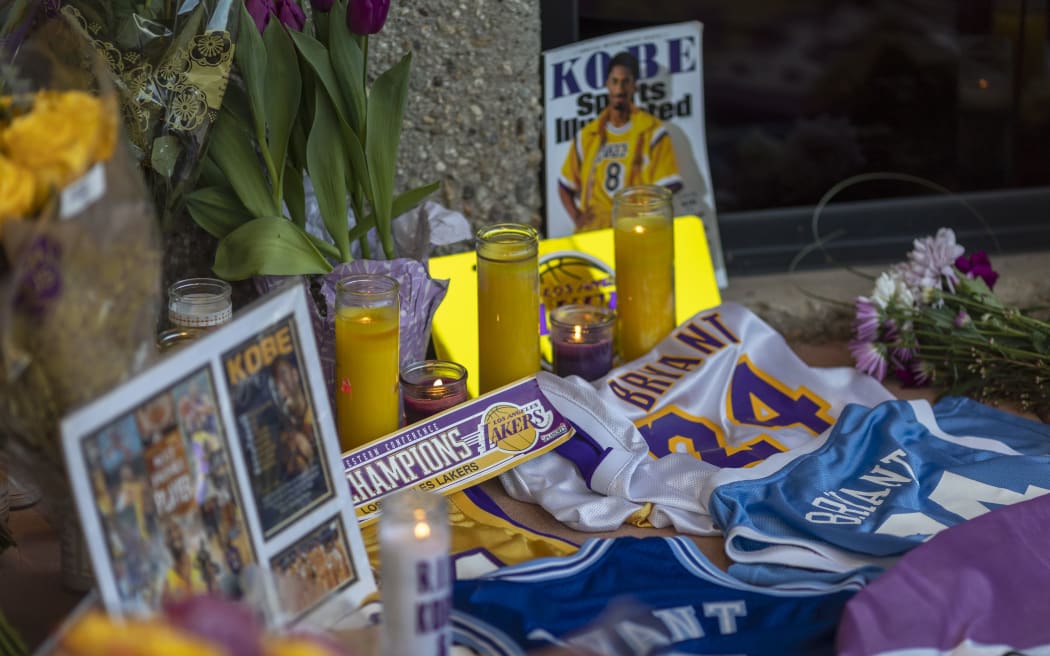 People mourn at a makeshift memorial at Mamba Sports Academy for former NBA great Kobe Bryant, who was killed in a helicopter crash while commuting to the academy on January 26, 2020 in Newbury Park, California.