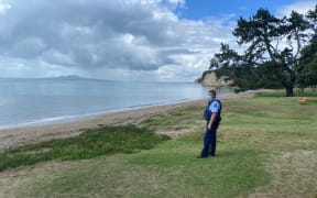 Police patrol a deserted Browns Bay in Auckland's North Shore.