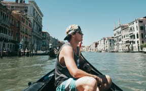 A young traveller on a boat in Venice