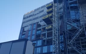 Fire and Emergency services extinguish a blaze at a building site on Graham Street, Auckland.