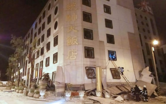 Rescue workers search through rubble outside the Marshal Hotel