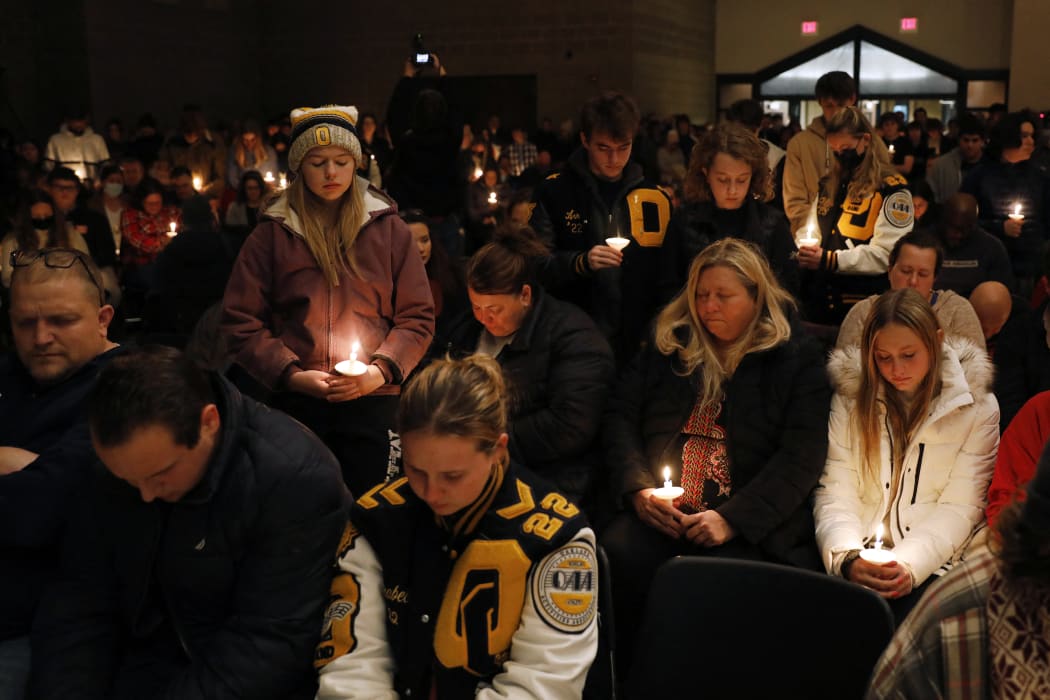 Oxford High students stand holding candles during a vigil after a shooting at Oxford High School at Lake Pointe Community Church in Lake Orion, Michigan.