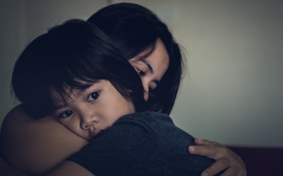 83600651 - mother and child, cute little boy resting on her mother's shoulder. young mother holding her sad boy at home.
