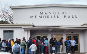 Workers line up outside the Māngere Memorial Hall waiting for interviews.
