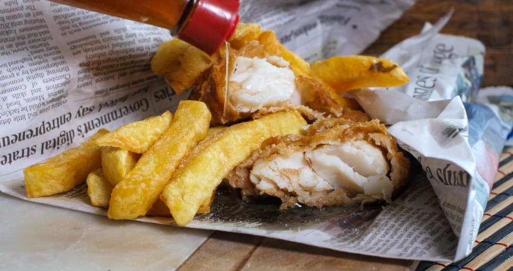 Fish and chips wrapped in newspaper.