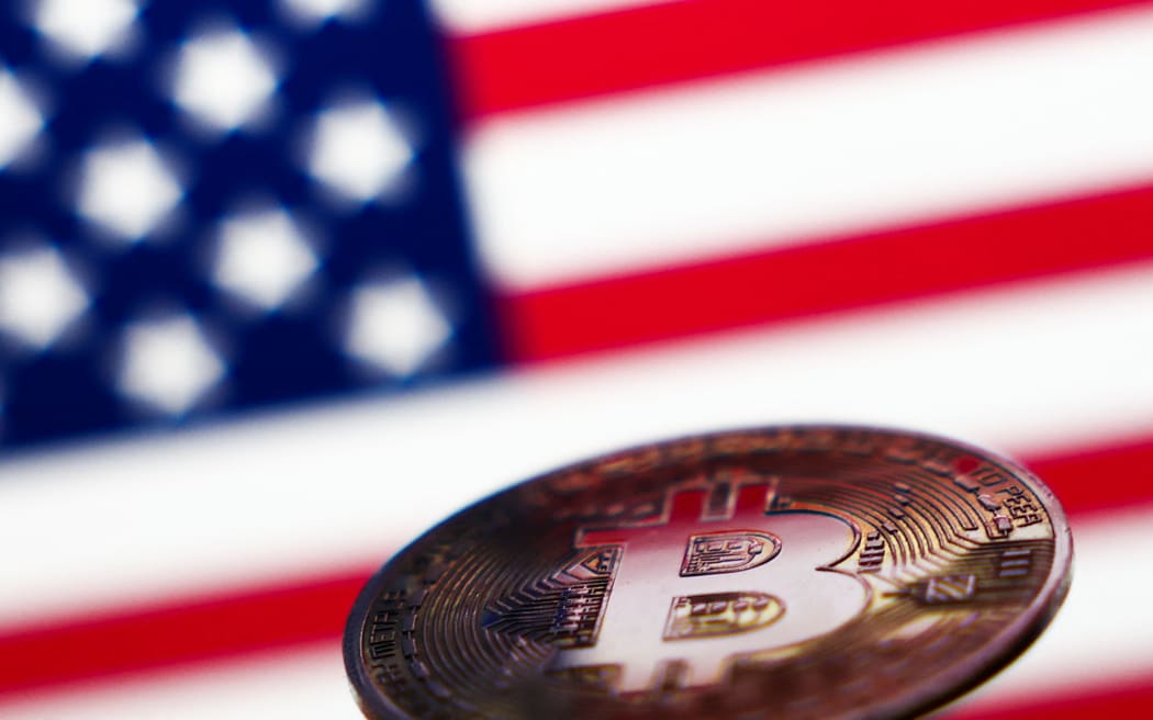 American flag displayed on a laptop screen and representation of Bitcoin cryptocurrency are seen in this illustration photo taken in Krakow, Poland on November 6, 2024. (Photo by Jakub Porzycki/NurPhoto) (Photo by Jakub Porzycki / NurPhoto / NurPhoto via AFP)