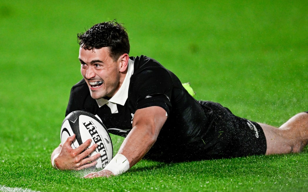 Will Jordan of New Zealand scores a try.