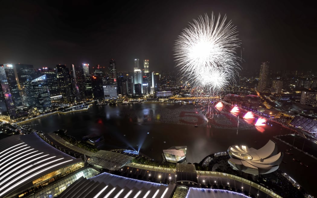 Fireworks burst over the Marina bay to mark the New Year's celebration in Singapore.