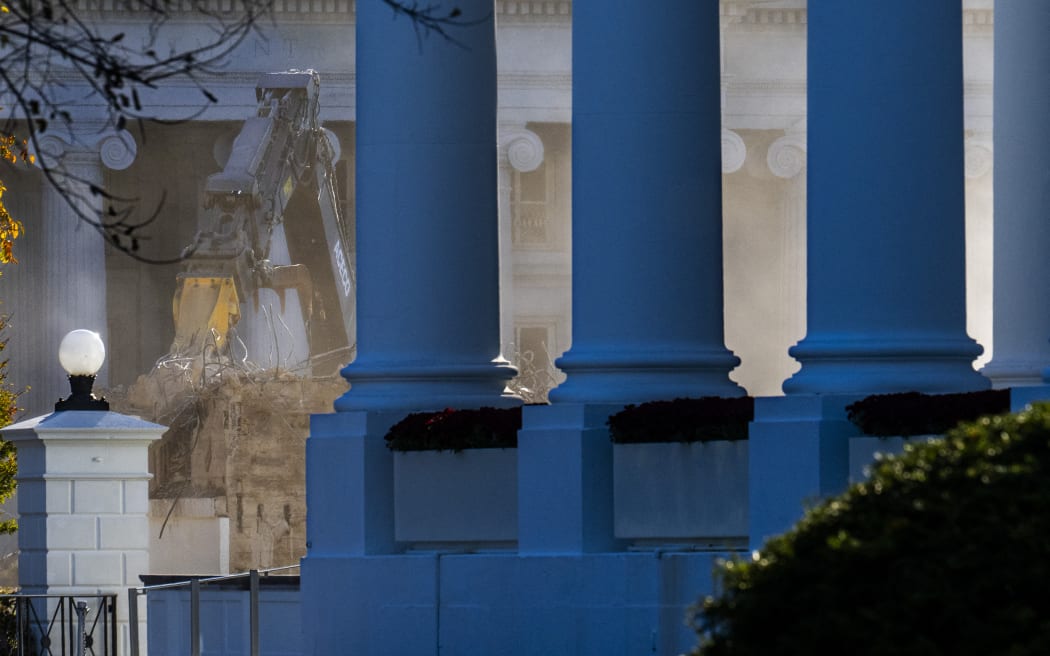 Demolition continues on the East Wing of the White House, with columns from the North Portico of the White House seen at right, on October 23, 2025, in Washington, DC. US President Donald Trump confirmed on October 22 that the White House's iconic East Wing is being torn down in its entirety to make way for a huge $300-million ballroom -- a far more extensive demolition than previously announced. Trump told reporters at an Oval Office event that he had decided after consulting architects that "really knocking it down" was preferable to a partial demolition. (Photo by Jim WATSON / AFP)