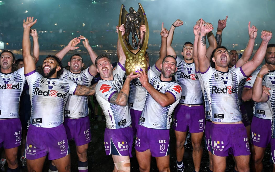 The Melbourne Storm lift the 2020 NRL Premiership trophy aloft after beating the Penrith Panthers 26-20 in the grand final in Sydney.