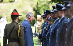 Prince Charles then inspected members of the armed forces lined up in the grounds of Government House.