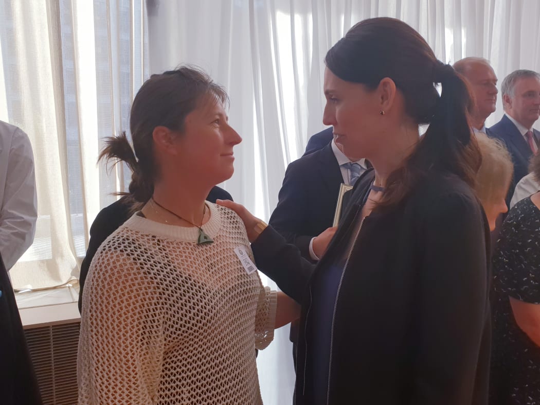 Prime Minister Jacinda Ardern shares a moment with Scott Theobold's wife Adriana at the public service awards at Parliament.