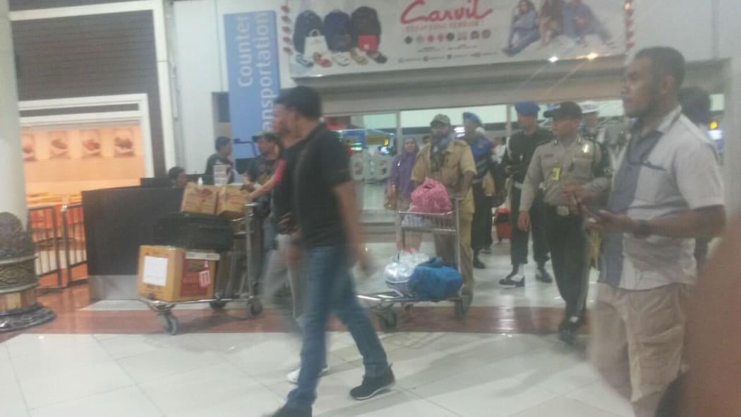 Filep Karma (centre with trolley) was taken in for questioning by police at Jakarta’s Sukarno Hatta airport.