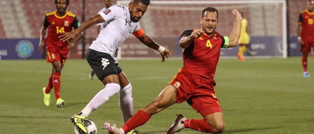 PNG captain Alwin Komolong tackles Fiji skipper Roy Krishna.
