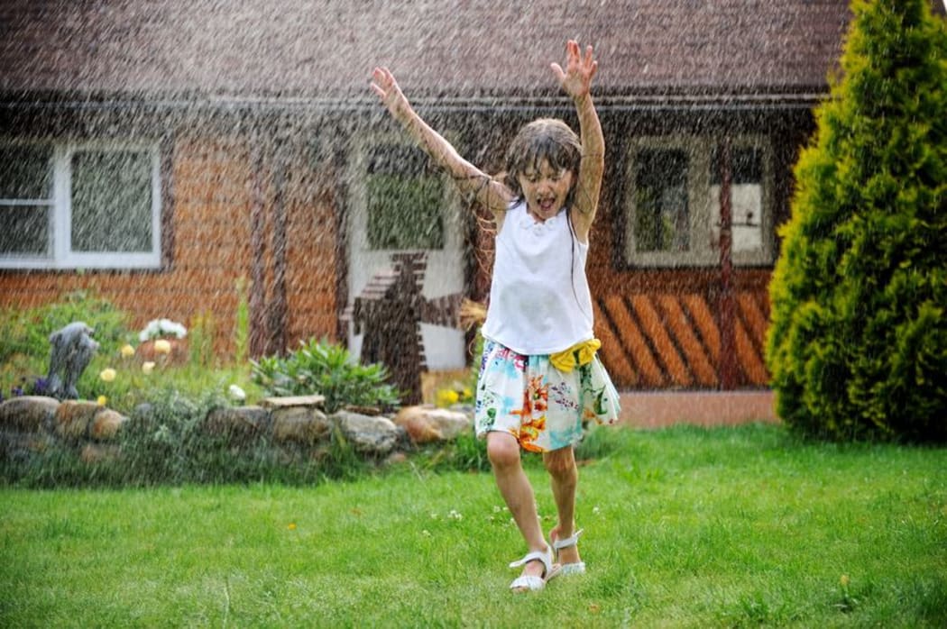 Child in the rain on a summer's day.