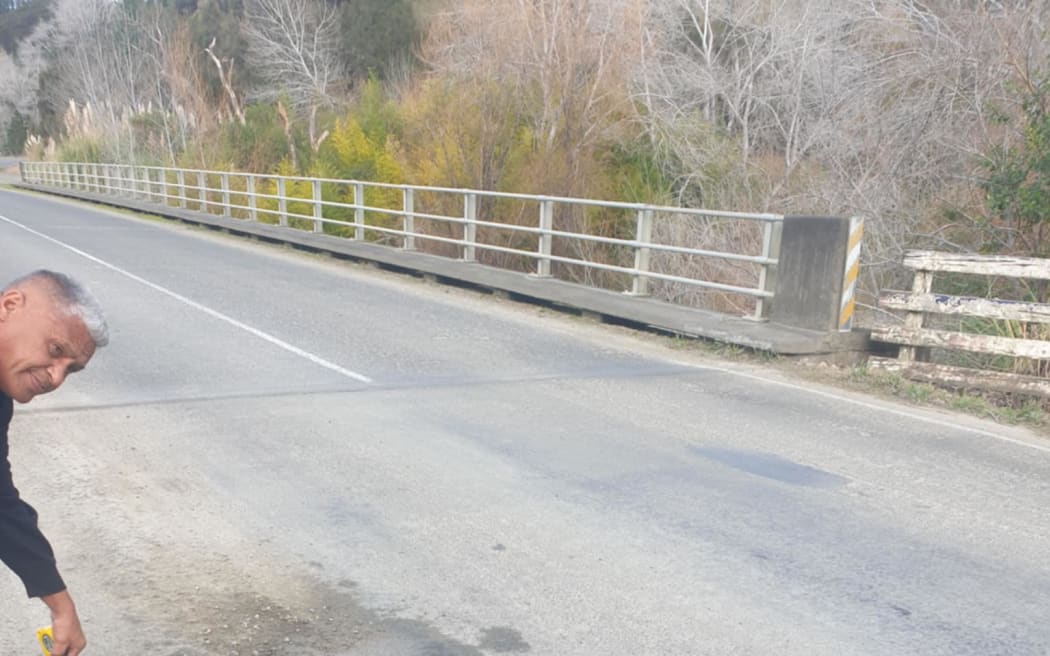 Whatatutu Resident and trustee and Chairperson of Te Wainui Marae Charitable Trust Niria Wainui-Teepa measuring a pothole.