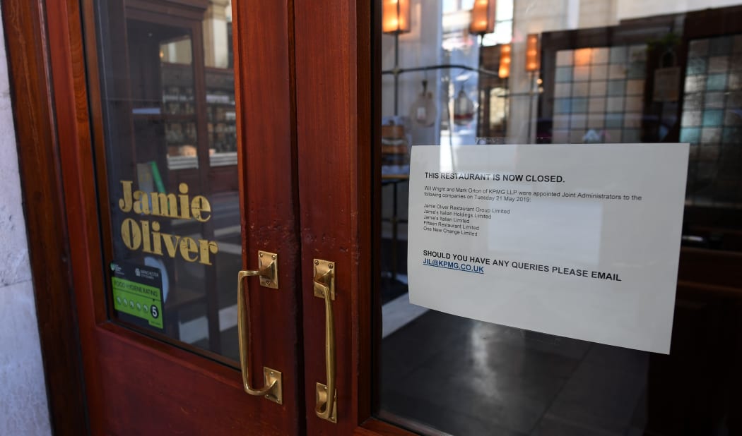 A sign in the door announcing the closure of a Jamie Oliver restaurant in Manchester, 21 May 2019.