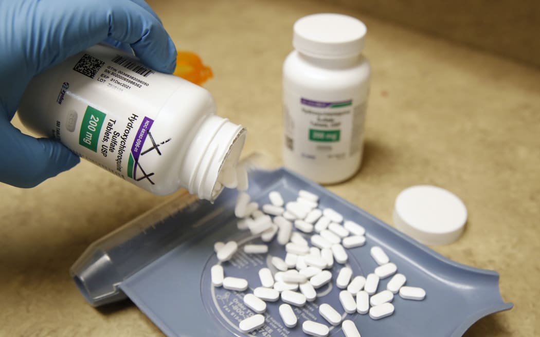 A pharmacy tech pours out pills of Hydroxychloroquine at Rock Canyon Pharmacy in Provo, Utah, on May 20, 2020.
