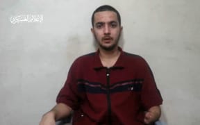 An image from a video released by Hamas on 24 April, 2024, showing Israeli-American Hersh Goldberg-Polin, 23, one of the hostages abducted from the Nova music festival in southern Israel during the Hamas attack on 7 October, 2023, speaking to a camera under duress.