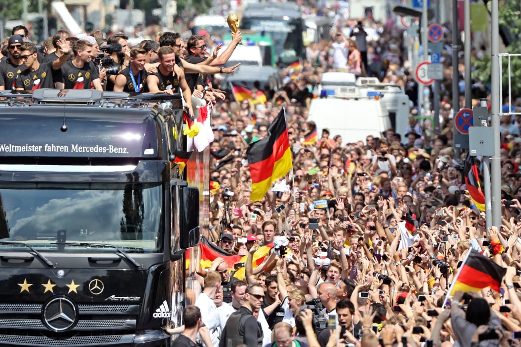 Players and members of the German national football team wave from a truck after their victory over Argentina.