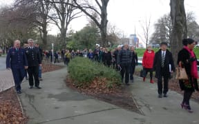 People walking to the proposed site of the national memorial for victims of the February 2011 earthquake on the edge of the Avon River.
