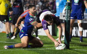 Grant Anderson of the Melbourne Storm scores a try against the Warriors.