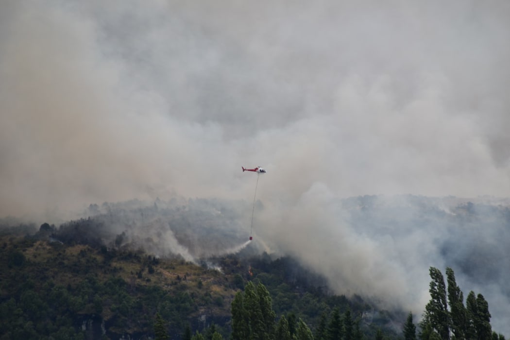 Helicopters with monsoon buckets continue to battle the fire.