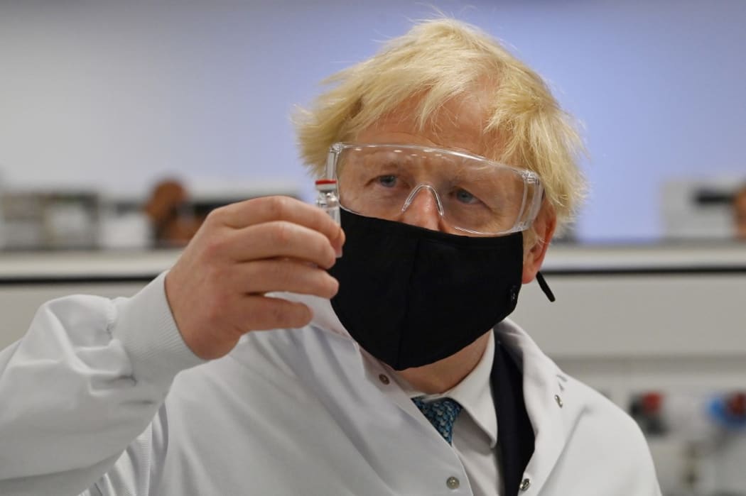 Britain's Prime Minister Boris Johnson poses for a photograph with a vial of the AstraZeneca/Oxford University COVID-19 candidate vaccine, known as AZD1222, at Wockhardt's pharmaceutical manufacturing facility in Wrexham, north Wales, on November 30, 2020.