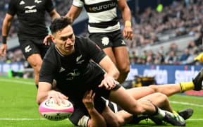 Shaun Stevenson of All Blacks XV dives in to score a try.