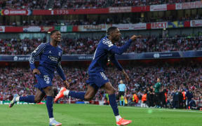 Paris Saint-Germain forward Ousmane Dembele, right, celebrates after scoring his team's goal against Arsenal in the UEFA Champions League semifinal first leg at Emirates Stadium in north London, on 20 April 2025.