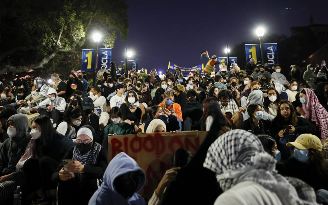Supporters of the pro-Palestinian protesters sit on stairs leading to an encampment set up by pro-Palestinian students and activists as they demonstrate on the campus of the University of California, Los Angeles (UCLA) in Los Angeles, California, on 1 May, 2024.