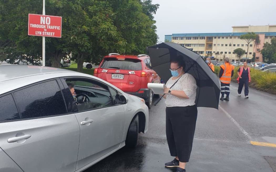 People queue for a Covid-19 test at Taranaki Base Hospital, where a line of cars hundreds of metres long snaked along Tukapa Street.