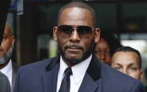 R. Kelly leaves a courthouse after an earlier hearing.