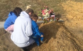 Amy and her two children at Peter's grave