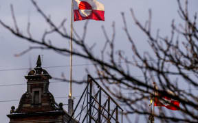 The Greenlandic flag (Erfalasorput) flies on the roof of Tivoli Castle in Copenhagen, on January 8, 2026. US President Donald Trump is discussing options including military action to take control of Greenland, the White House said on January 6, 2025, upping tensions that Denmark warns could destroy the NATO alliance. Trump has stepped up his designs on the mineral-rich, self-governing Danish territory in the arctic since the US military seized Venezuelan leader Nicolas Maduro on January 3, 2026. (Photo by Ida Marie Odgaard / Ritzau Scanpix / AFP) / Denmark OUT / DENMARK OUT / DENMARK OUT