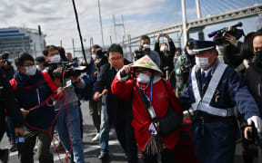 A passenger leaves after dismembarking the Diamond Princess cruise ship in quarantine at Yokohama.