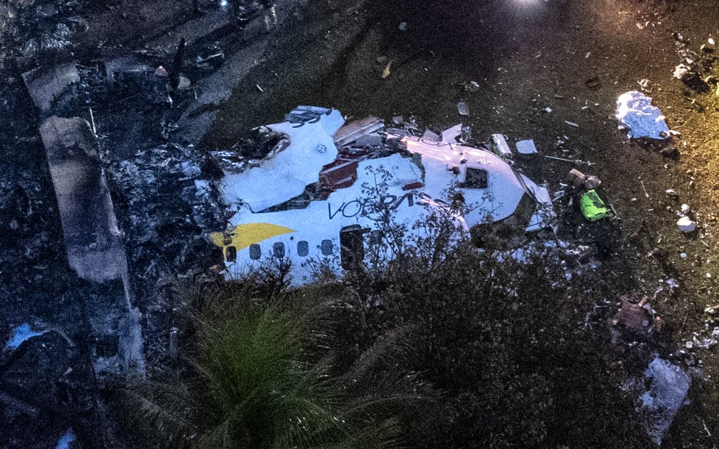 Aerial view of the wreckage of an airplane that crashed with 61 people on board in Vinhedo, Sao Paulo State, Brazil, on August 9, 2024. An airplane carrying 57 passengers and four crew crashed on August 9 in Brazil's Sao Paulo state, killing everyone on board, local officials said. The aircraft, a French-made ATR 72-500 operated by the airline Voepass, was travelling from Cascavel in southern Parana state to Sao Paulo's Guarulhos international airport when it crashed in the city of Vinhedo. (Photo by Miguel SCHINCARIOL / AFP)