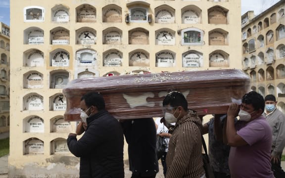 Relatives of a Covid-19 victim carry a coffin at the General Cemetery in the central city of Huanuco, 375km northeast of Lima.