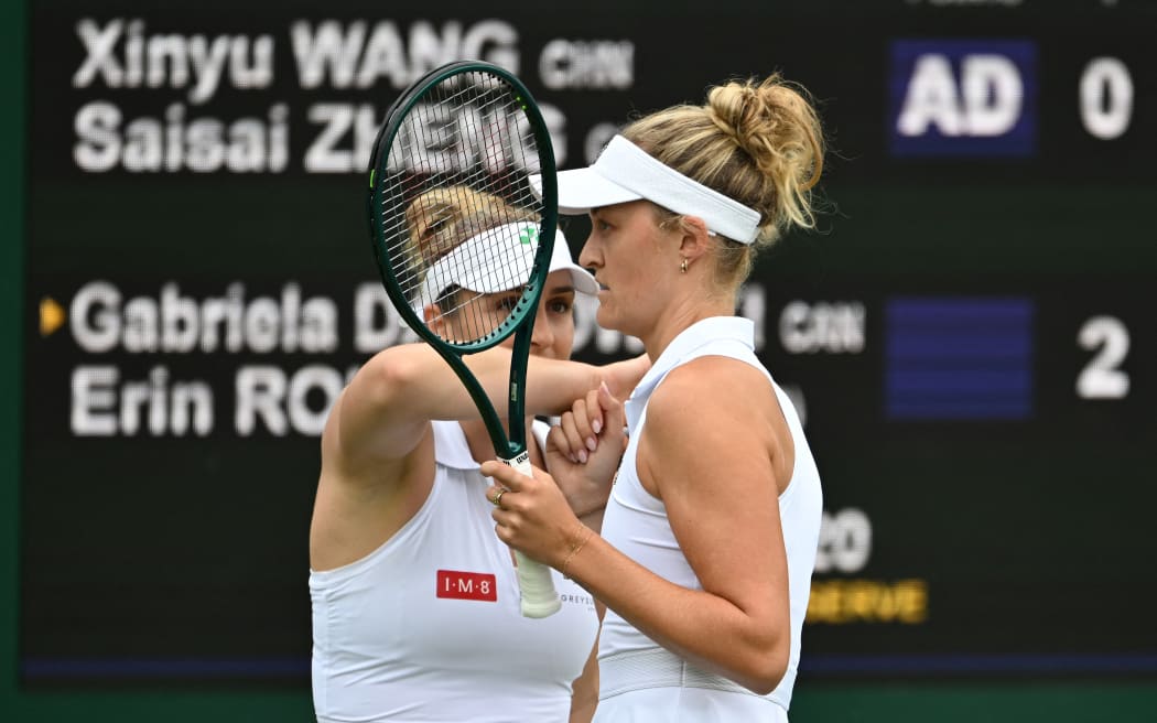 Gaby Dabrowski, left, and New Zealander Erin Routliffe react during the women's doubles first round match against Wang Xinyu and Zheng Saisai at Wimbledon, July 2, 2025.  (Photo by Zhao Dingzhe / Xinhua via AFP)