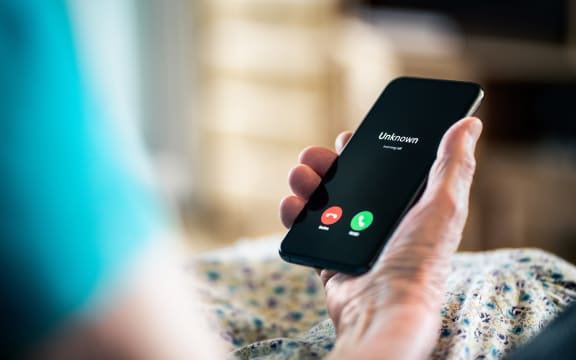 Old woman and phone call with hidden mobile number. Senior mature lady and fraud and scam caller. Love and romance hoax. Holding smartphone in hand. Catfish or scammer. Phishing concept.