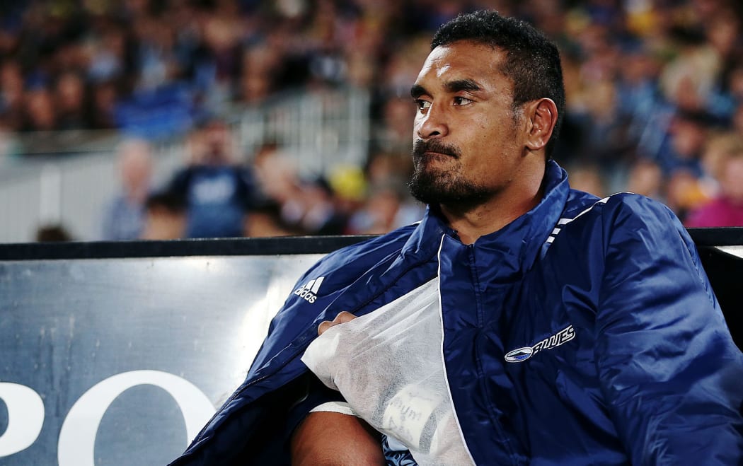 The injured Jerome Kaino looks on from the bench.