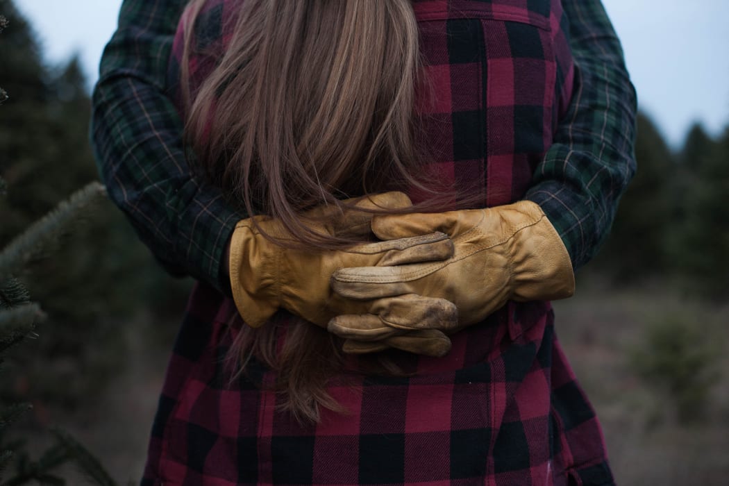 couple hugging, man with yellow gloves