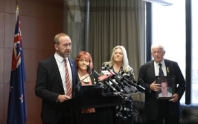 Andrew Little making the announcement at Parliament alongside the families of the men who died in the Pike River Mine.