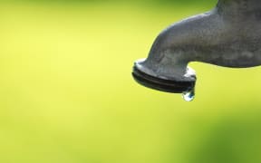 Detail of dripping faucet with water drop