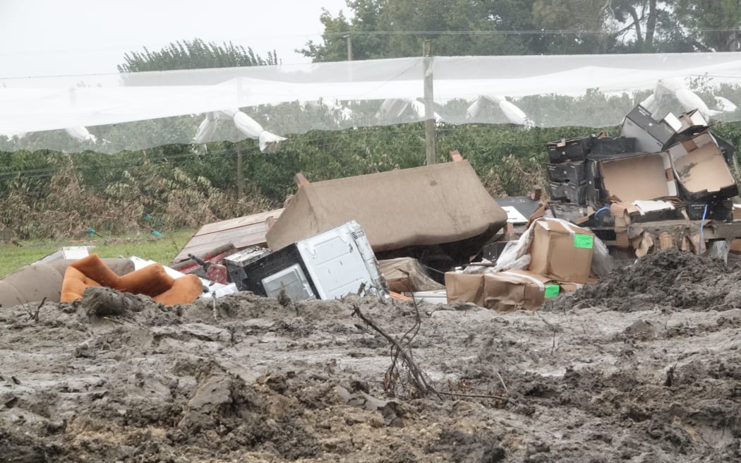 Van Beek, his family and staff are piling silt and rubbish were apple trees once stood.