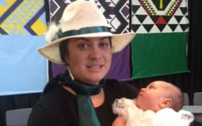 Racquel McKenzie and her baby Te Kopere after his baptism at the 70th Hui Aranga in March 2016.