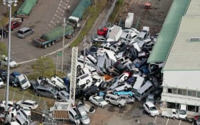 An aerial view from a Jiji Press helicopter shows vehicles piled in a heap due to strong winds in Kobe.