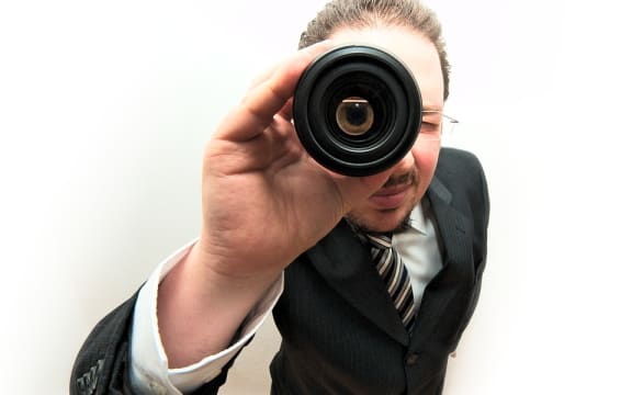 Man looking through lens