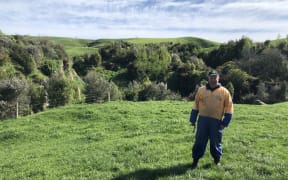 Farmer Chris Lewis near a grove of trees planted six years ago
