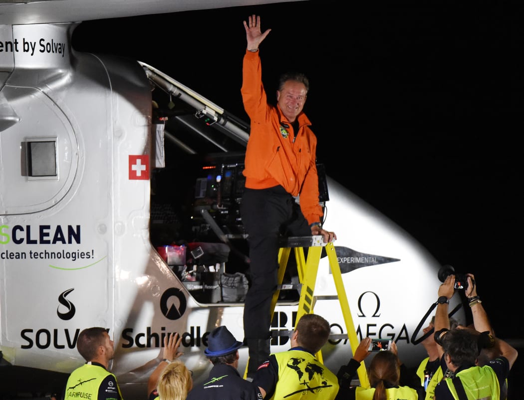 Swiss pilot Andre Borschberg emerges from the cockpit after successfully landing the Solar Impulse 2.